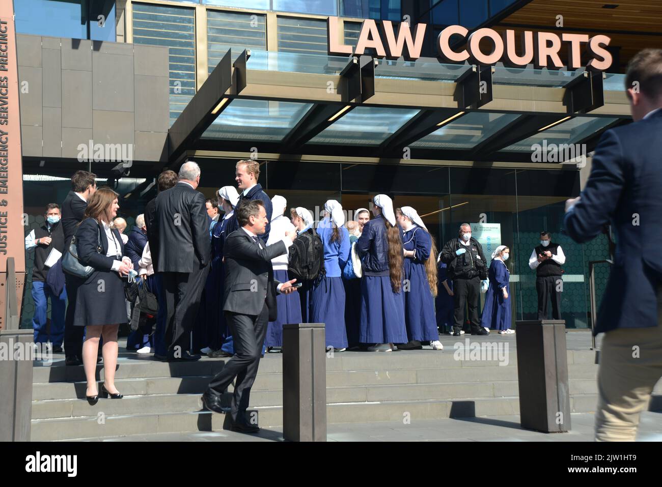 CHRISTCHURCH, NEW ZEALAND, AUGUST 29, 2022: Members of the Gloriavale Christian Community gather outside the Justice Precinct building in Christchurch where a hearing was underway over the employment status of women in the community. Stock Photo