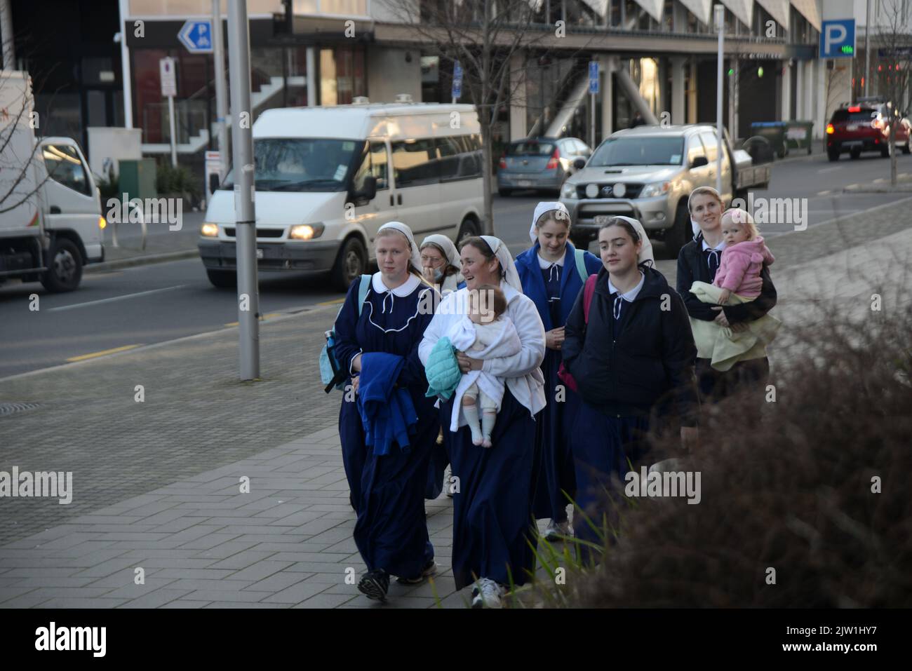 CHRISTCHURCH, NEW ZEALAND, AUGUST 29, 2022: Members of the Gloriavale Christian Community approach the Justice Precinct building in Christchurch where a hearing was underway over the employment status of women in the community. Stock Photo
