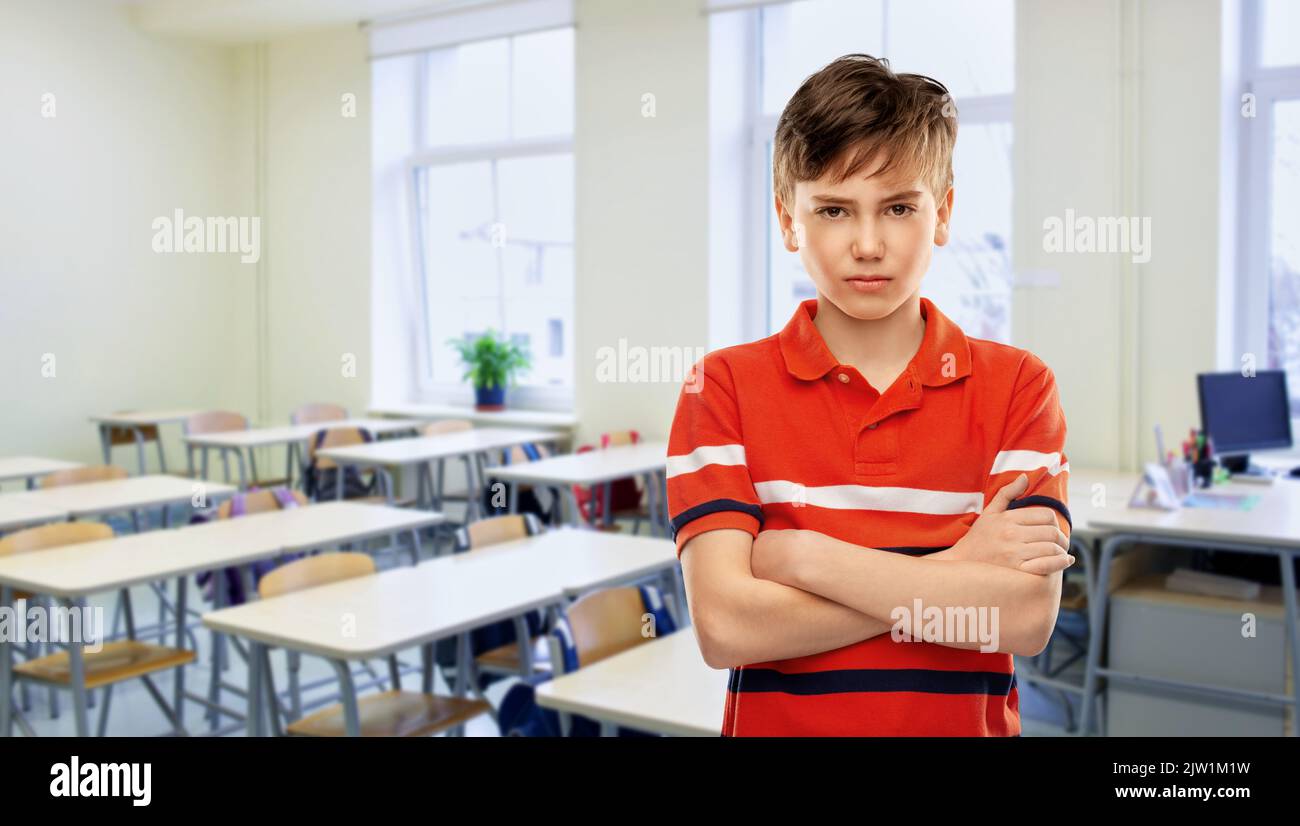 angry boy in red polo t-shirt at school Stock Photo