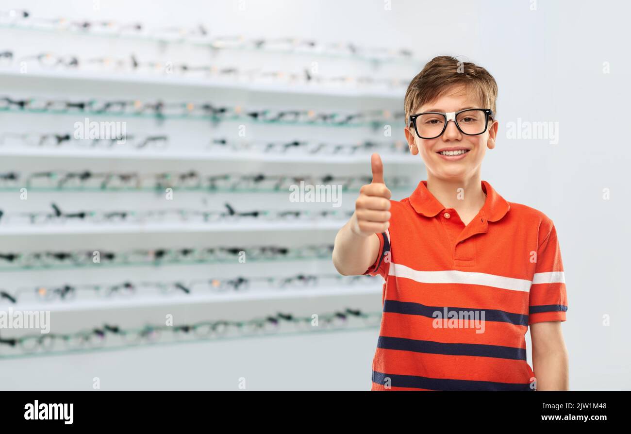 boy in glasses showing thumbs up at optics store Stock Photo - Alamy