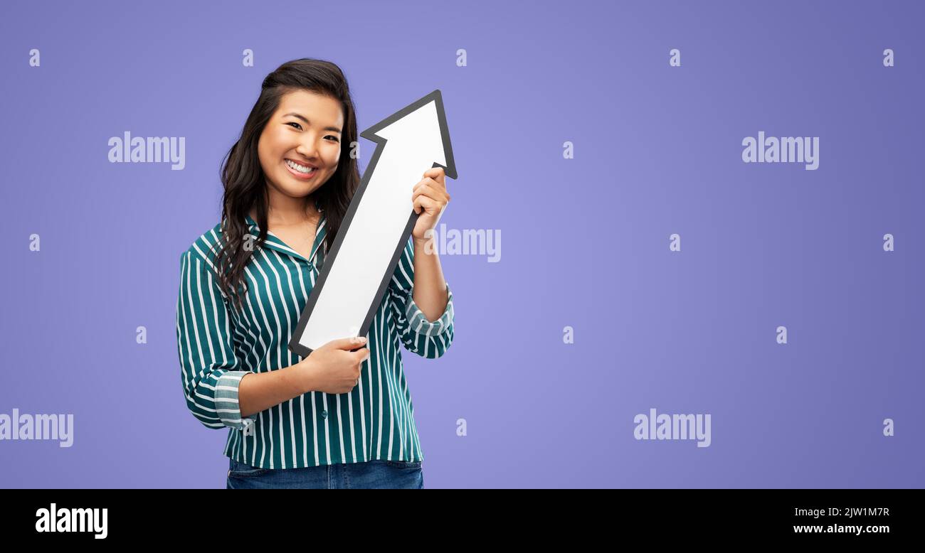 happy smiling woman with arrow pointing up Stock Photo - Alamy