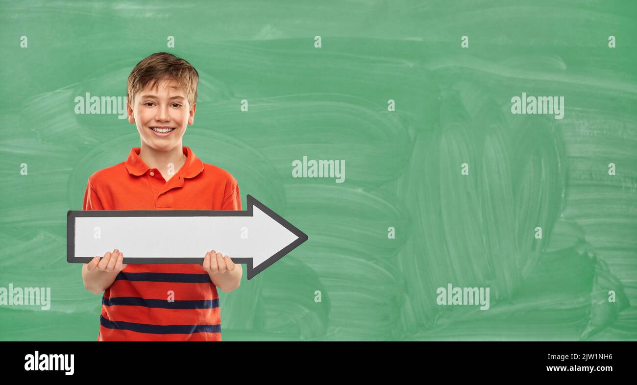 happy boy holding big white rightwards thick arrow Stock Photo - Alamy