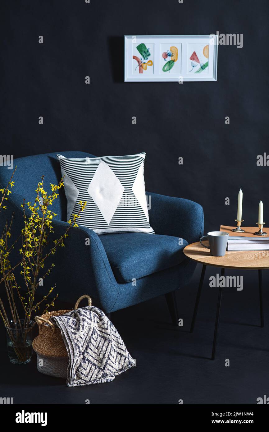 chair, table and blanket in basket in dark room Stock Photo