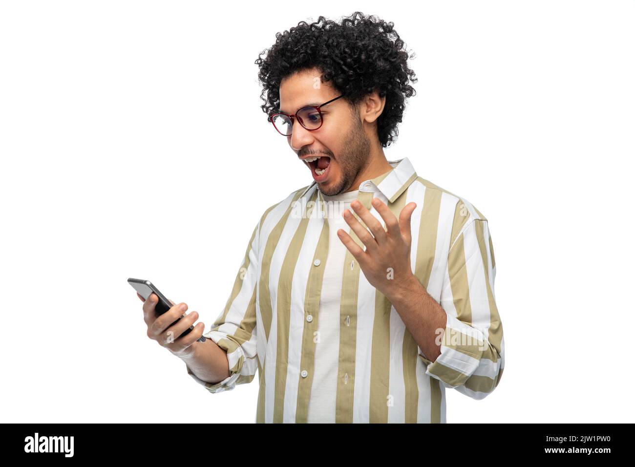 surprised young man with smartphone Stock Photo