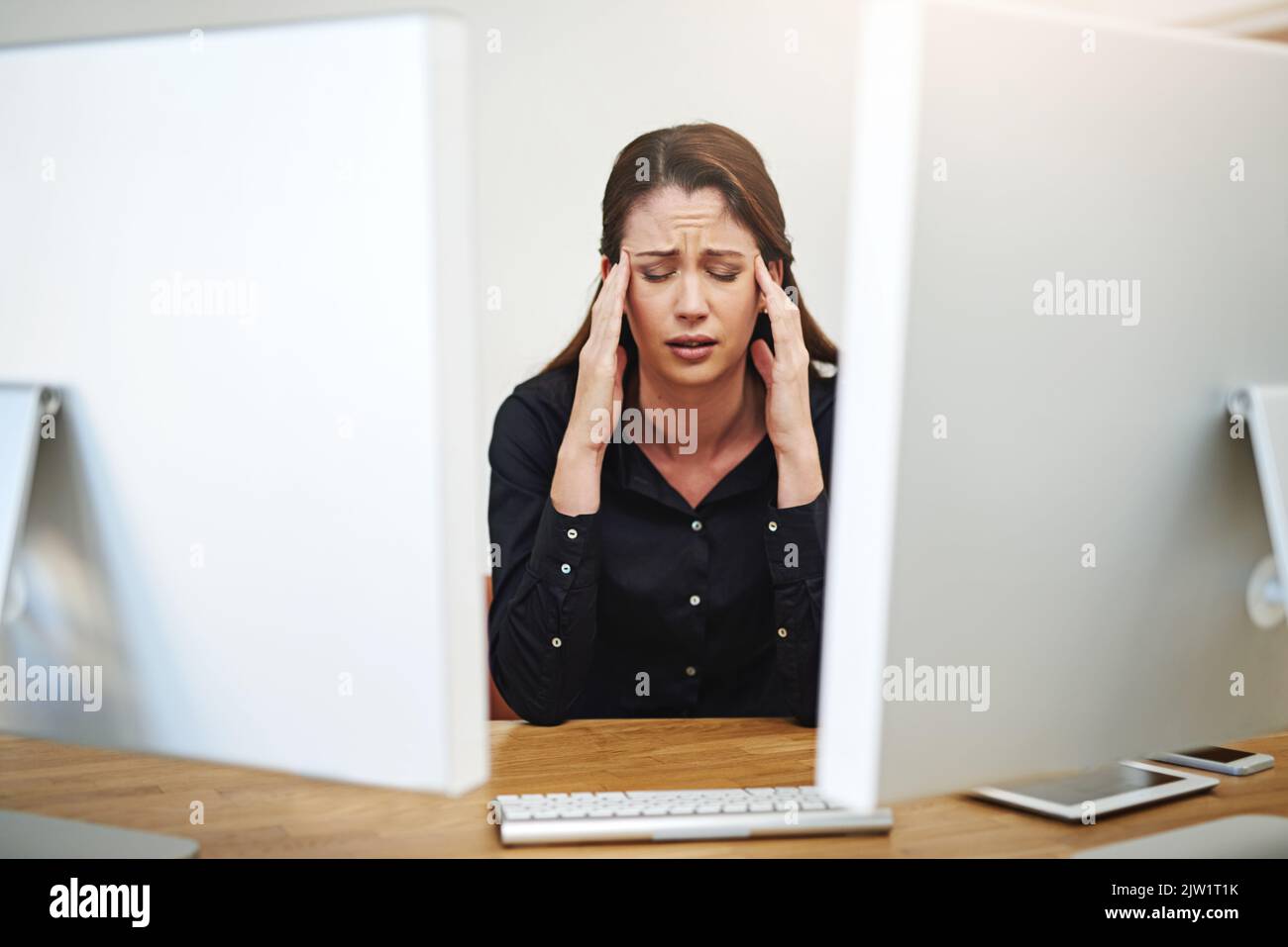 Works got her feeling frazzled. a young businesswoman having a bad day at work. Stock Photo