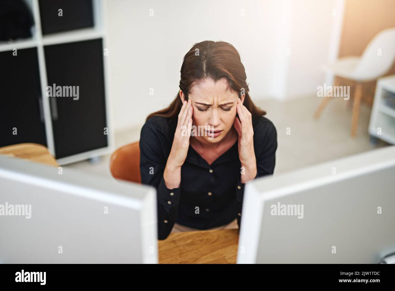 I need a day off. a young businesswoman having a bad day at work. Stock Photo