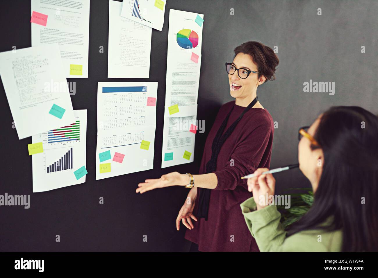 Presenting her proposal. coworkers brainstorming in a modern office. Stock Photo