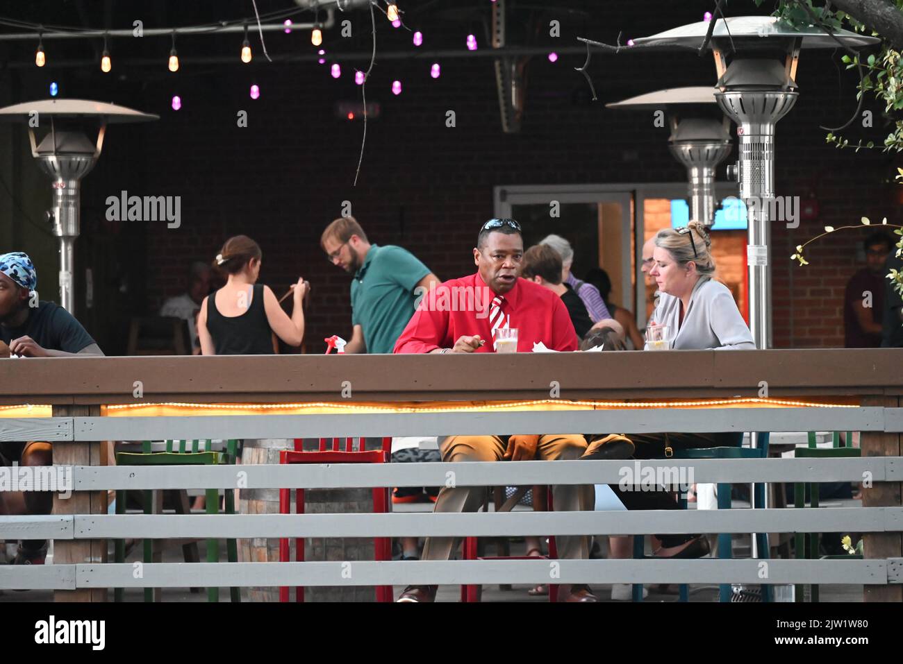 Customers on the outdoor patio at the Street Food Hall in