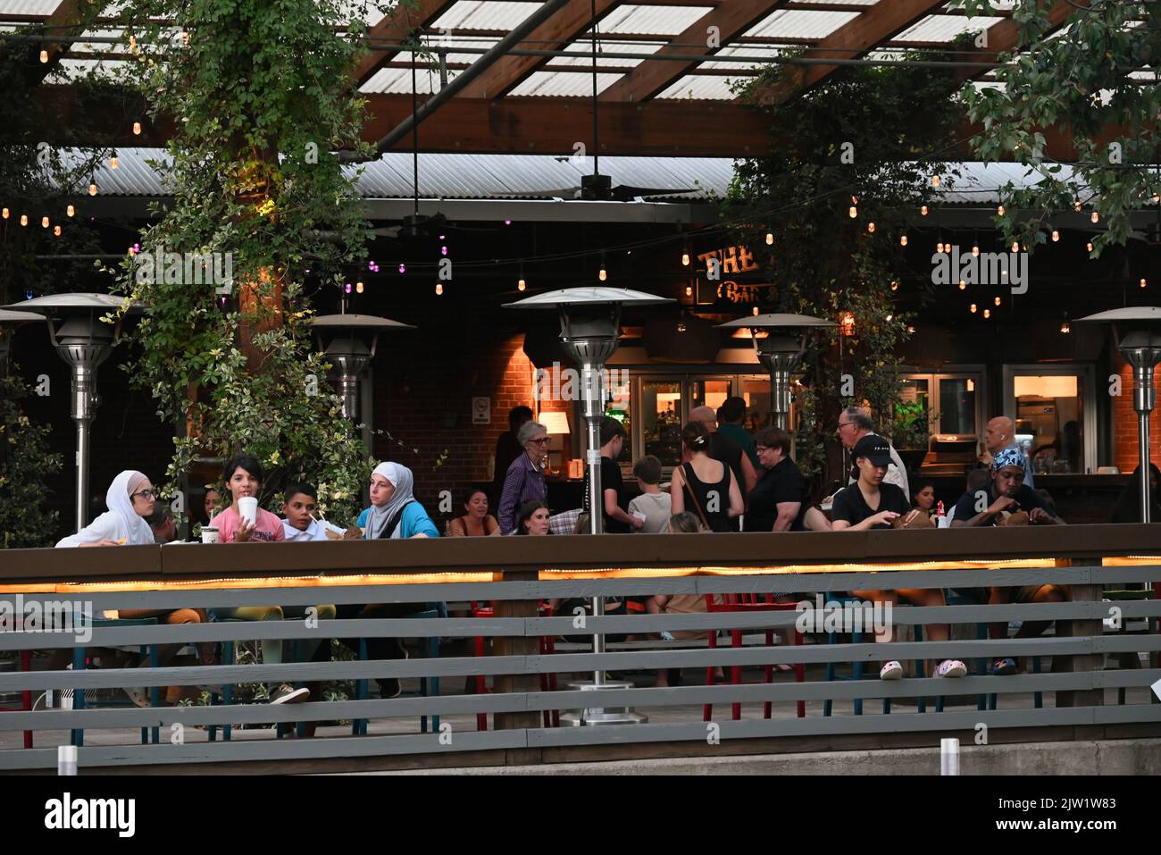 Customers on the outdoor patio at the Street Food Hall in