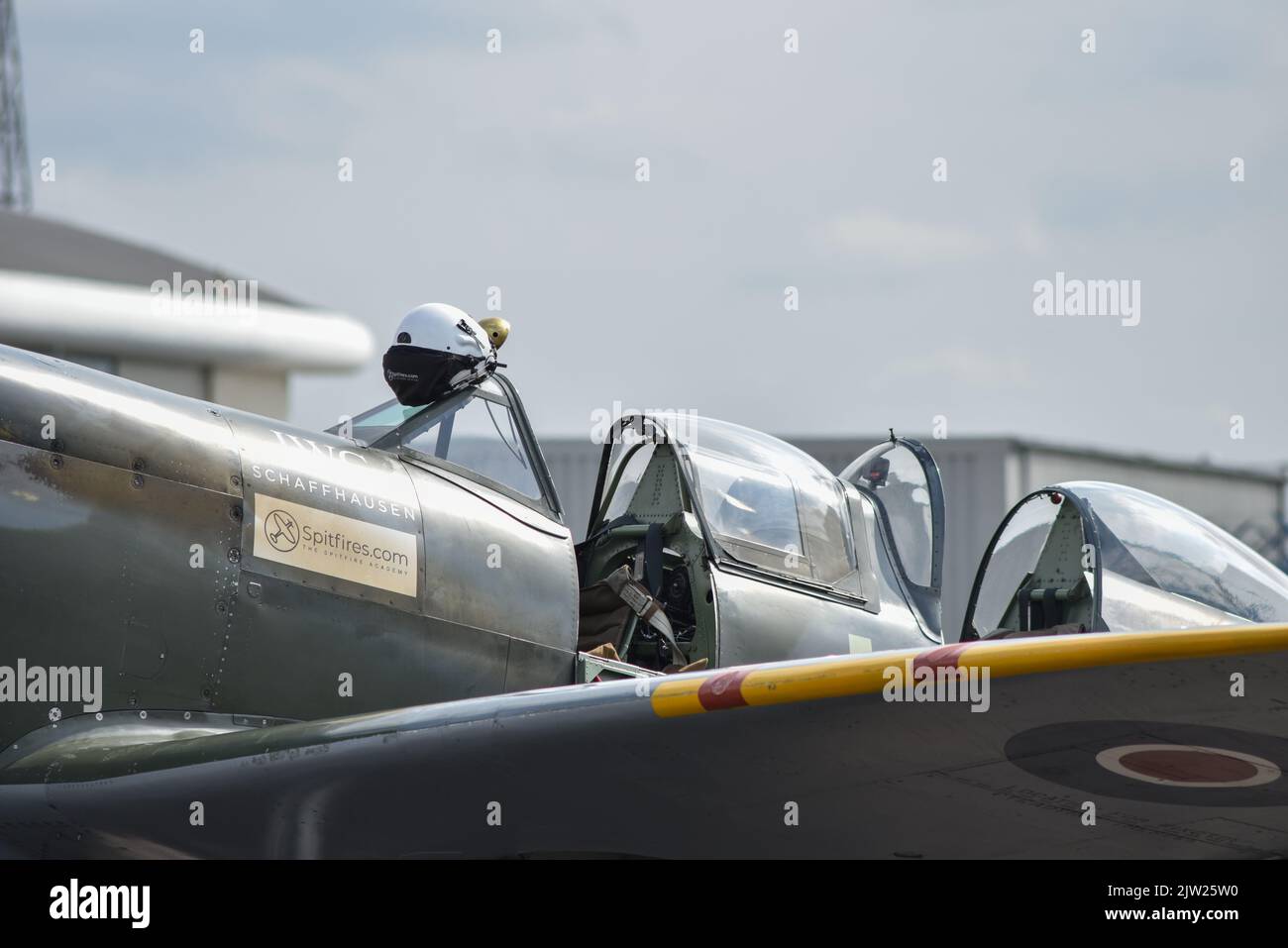 SM250 twin seat Spitfire parked on the runway of Solent airport in England. Glass canopy open and cockpit visible. Stock Photo