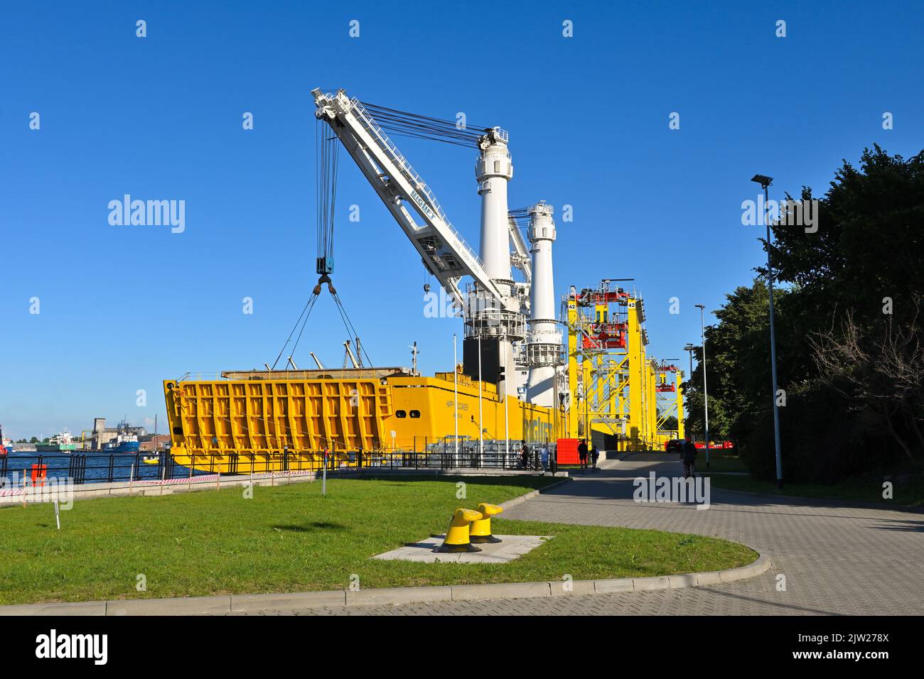 Gdansk, Poland, 3 July, 2022: Big crane and a sea ship in the port of Gdanski Stock Photo