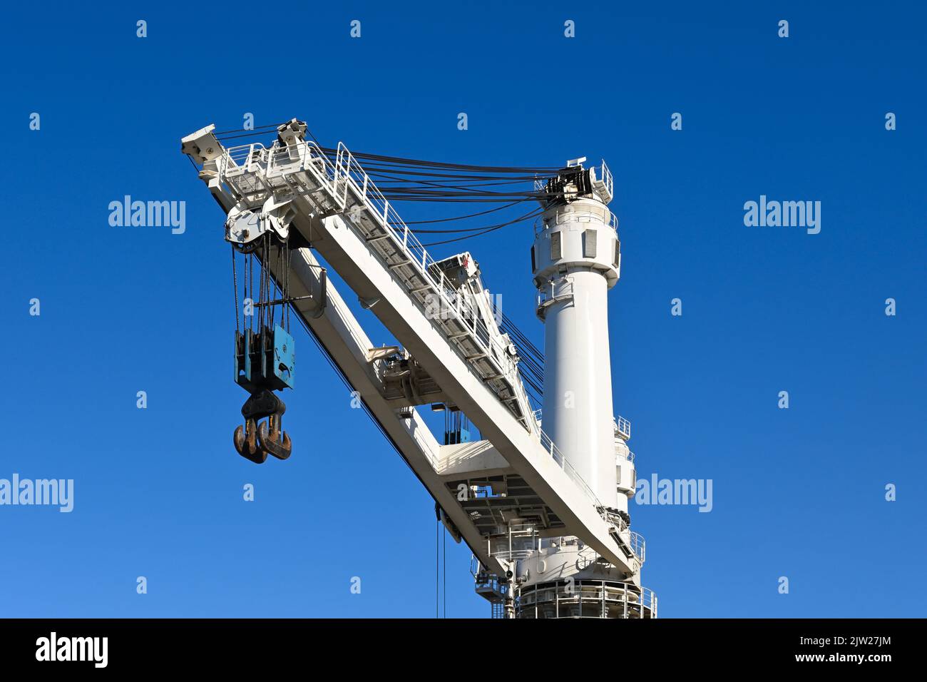 Outdoor crane used in ship industry, electric overhead traveling crane above the vessel Stock Photo
