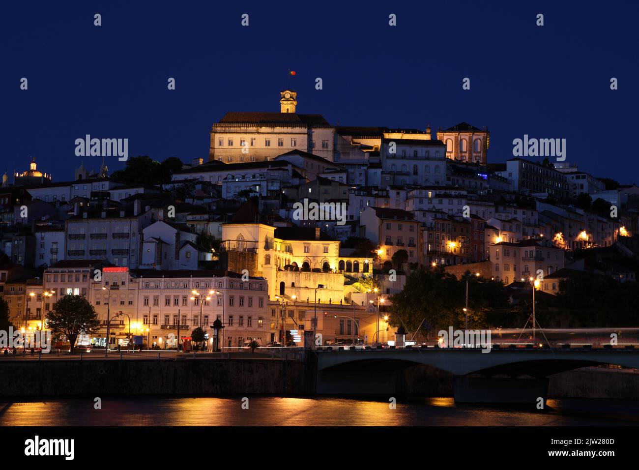 Night time photo of Coimbra cityscape. Coimbra is an historic university city in Portugal. The University was founded in 1290 and is one of the oldest Stock Photo