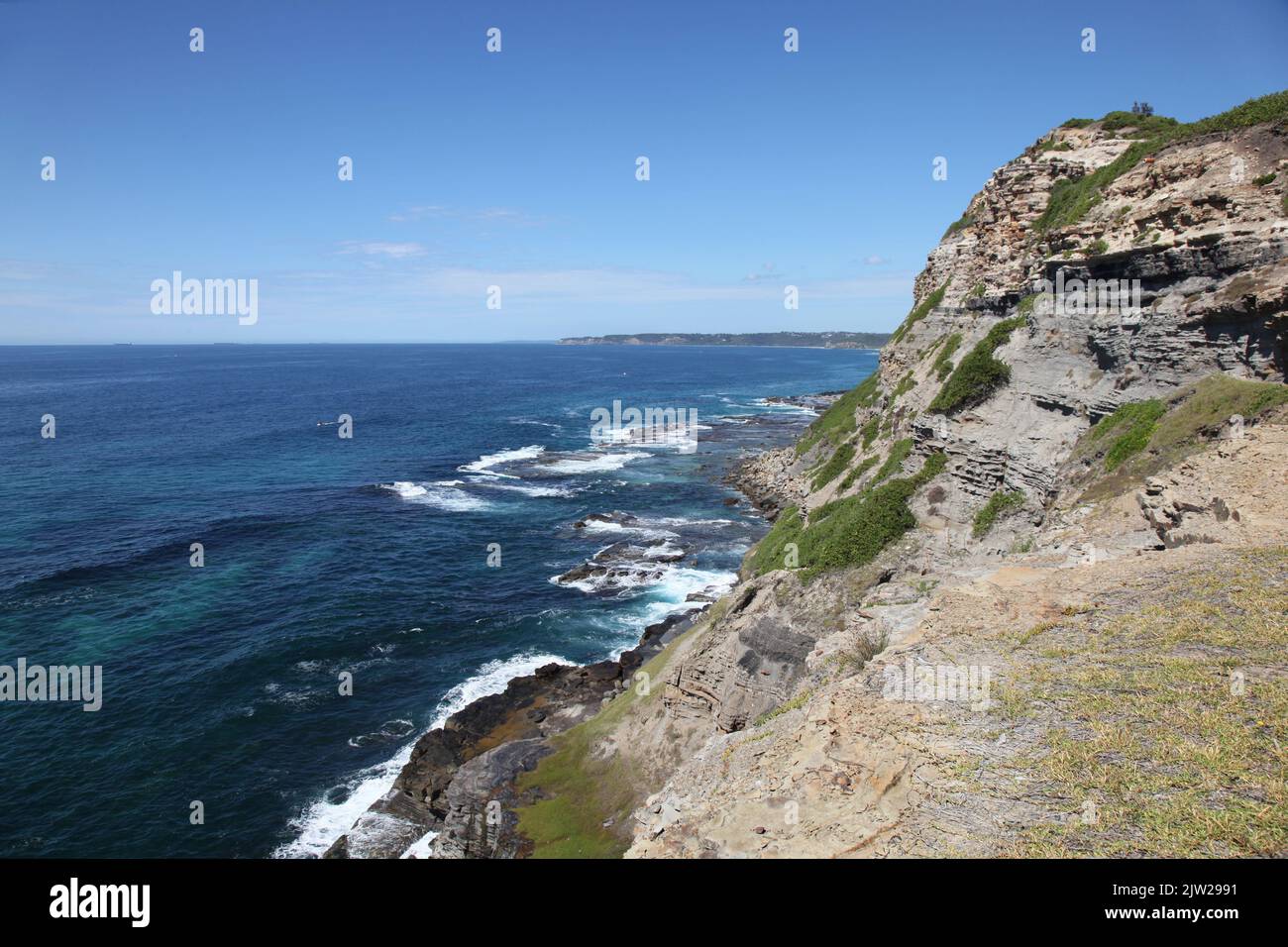Rugged coastal cliff and rock platforms Newcastle Australia Stock Photo