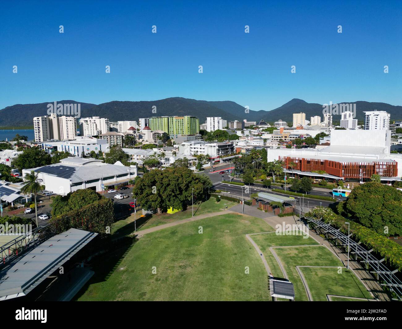 Aerial photo of park and city scape with mountains and blue sky in the background Stock Photo