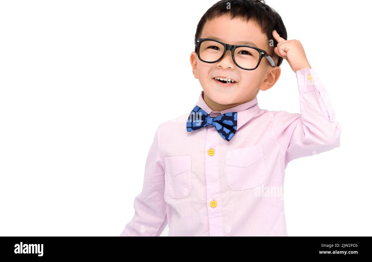 Smart kid standing over white background and  pointing to head with one finger Stock Photo