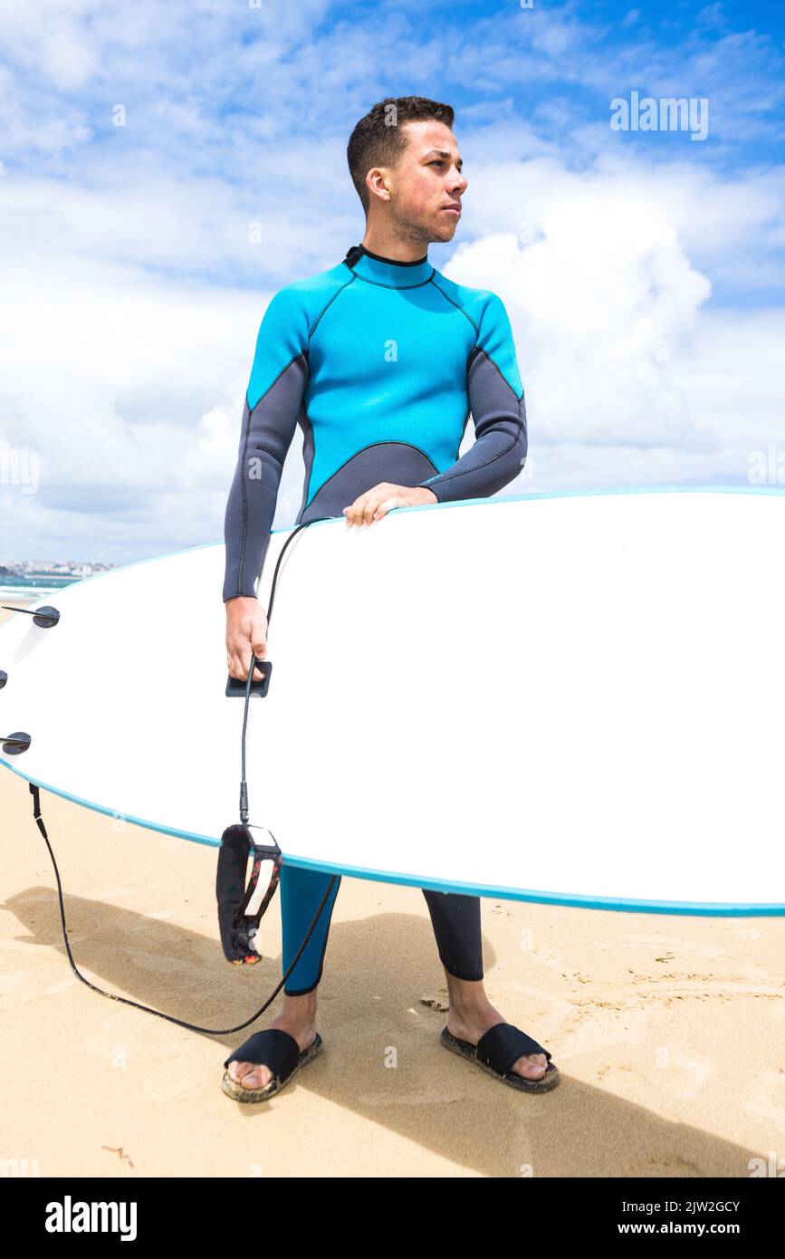Full body of young thoughtful Hispanic male surfer with dark hair and ...