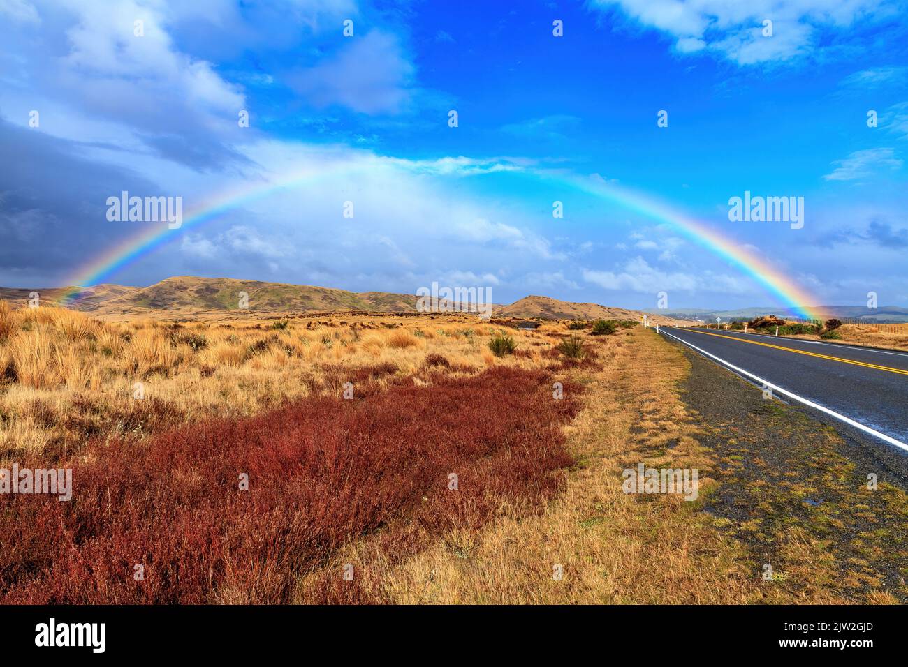 A rainbow over the Desert Road in the Volcanic Plateau of New Zealand's North Island Stock Photo