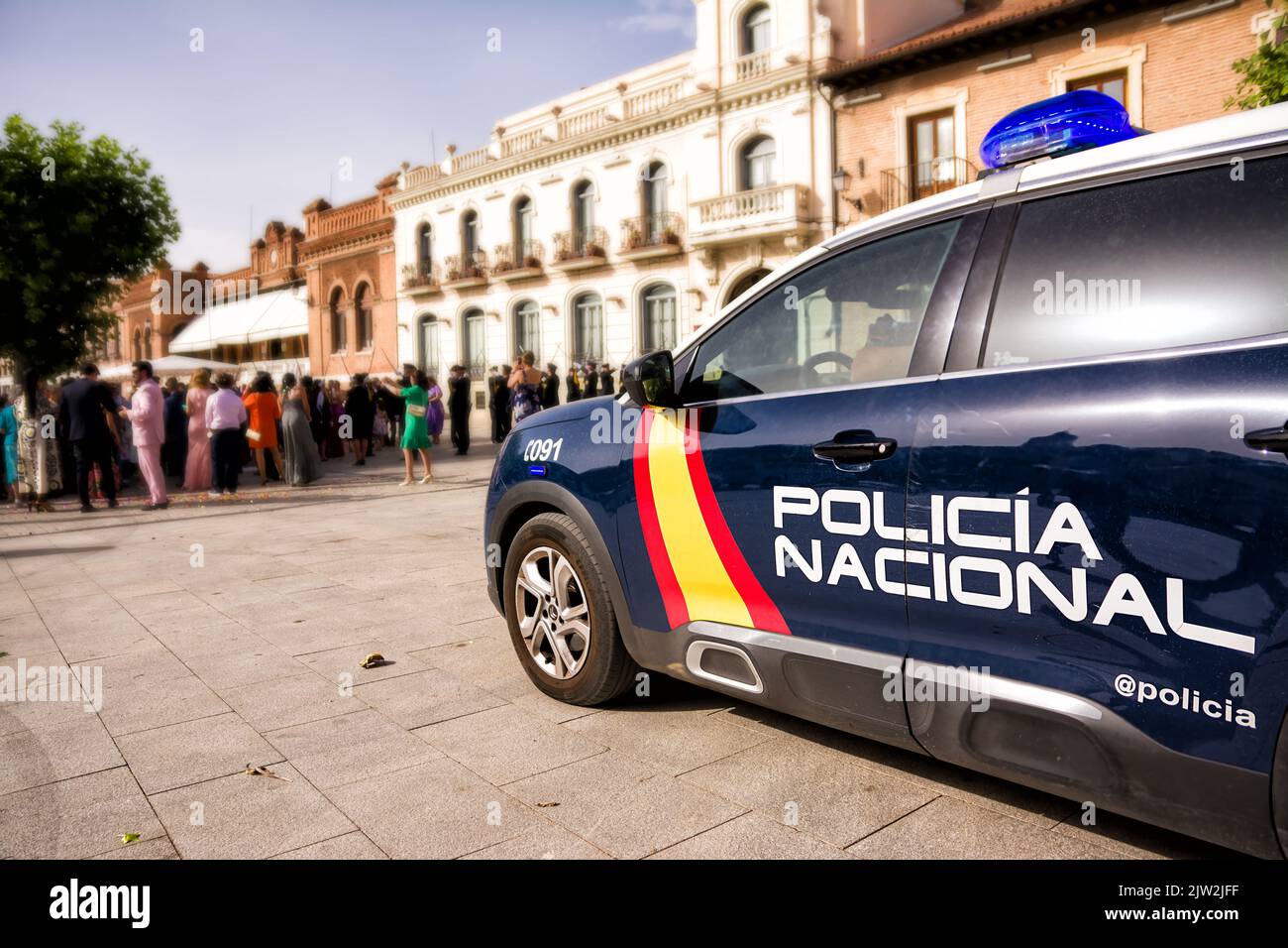 Police car with crowd in the background Stock Photo