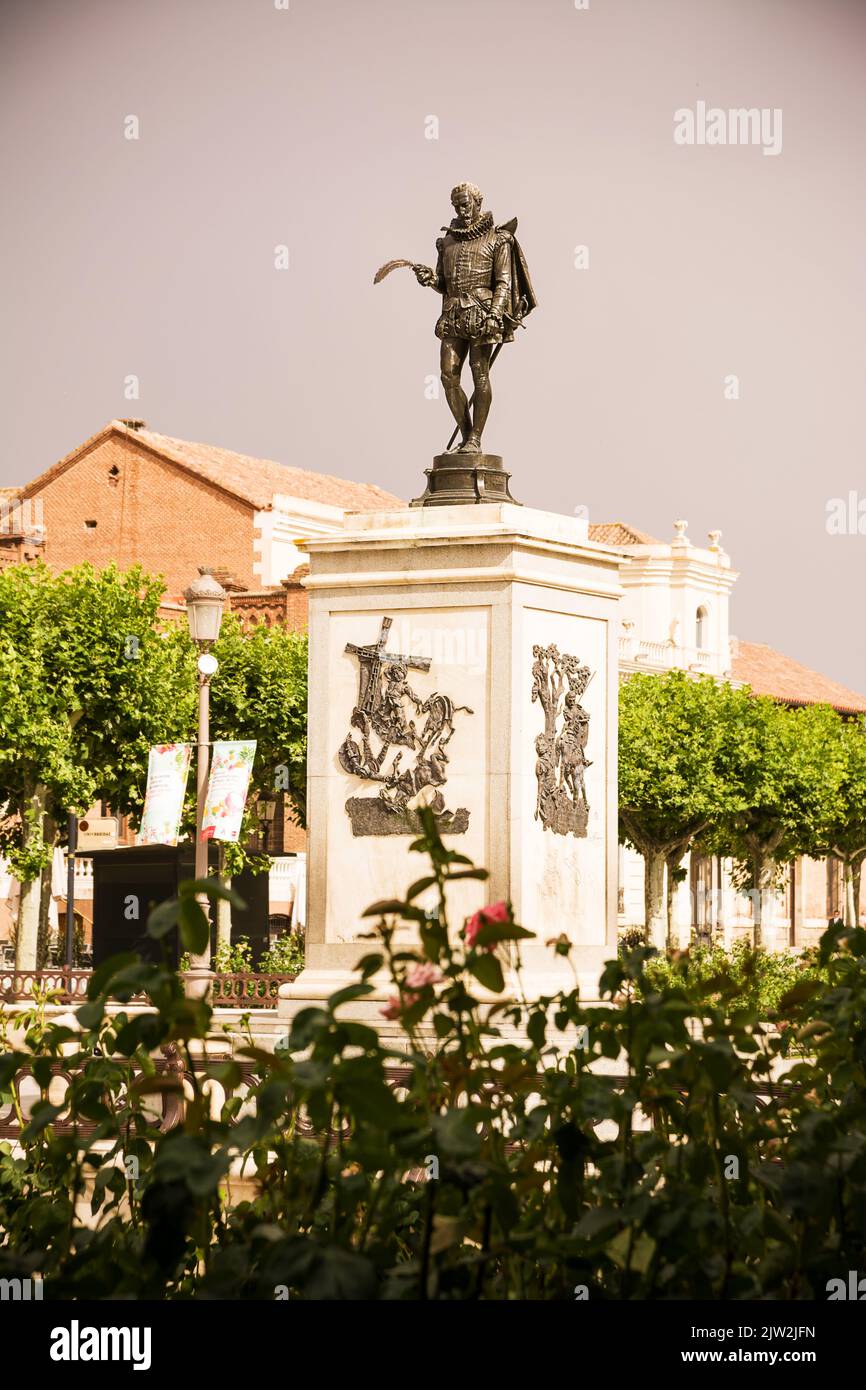 Alcala de Henares, Spain - June 18, 2022: Statue of Miguel de Cervantes and sub-scenes of his most famous novel The Quixote in the center of the squar Stock Photo