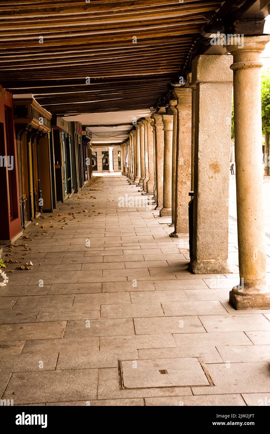 Historic arcade in the center of Halcalá with stone columns and wooden ceiling Stock Photo