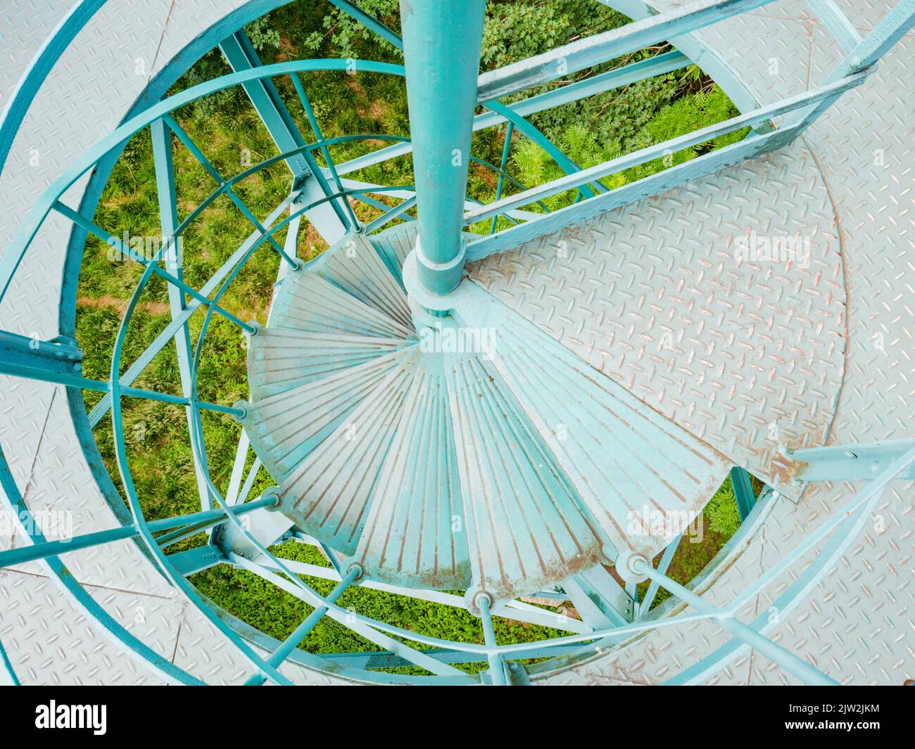 Metal spiral staircase leading the lookout tower. Perforated stairs made of steel sheets with