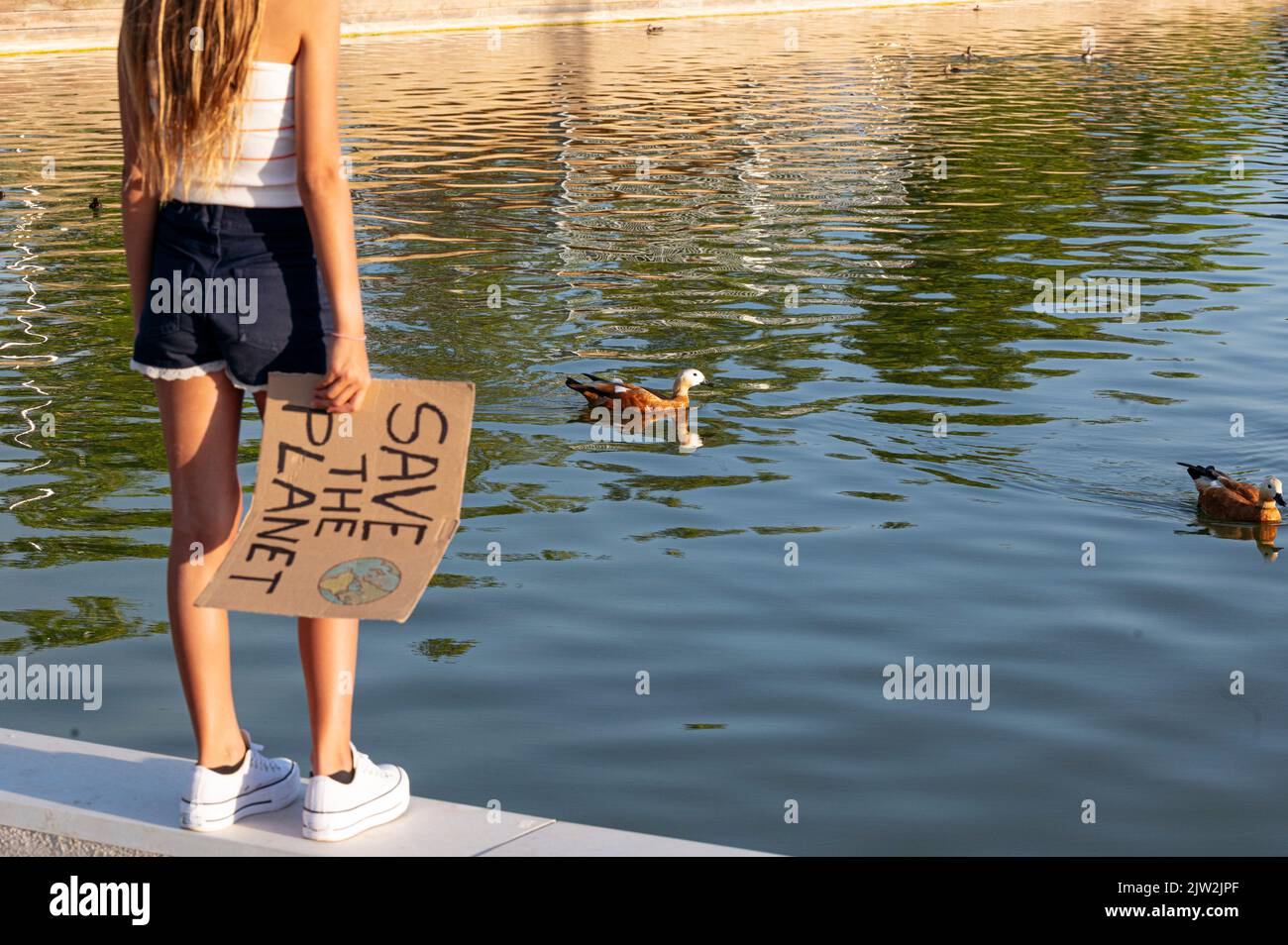 https://c8.alamy.com/comp/2JW2JPF/cropped-unrecognizable-teenage-girl-holding-cardboard-poster-with-save-the-planet-inscription-standing-on-street-park-on-summer-day-2JW2JPF.jpg