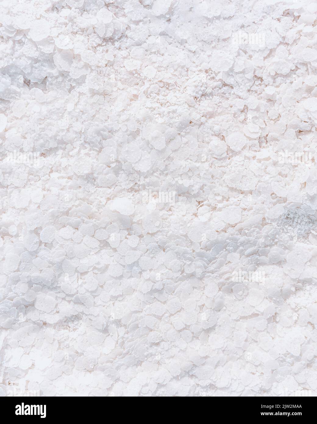 Full frame textured background of rough white mineral surface with crystals of salt Stock Photo