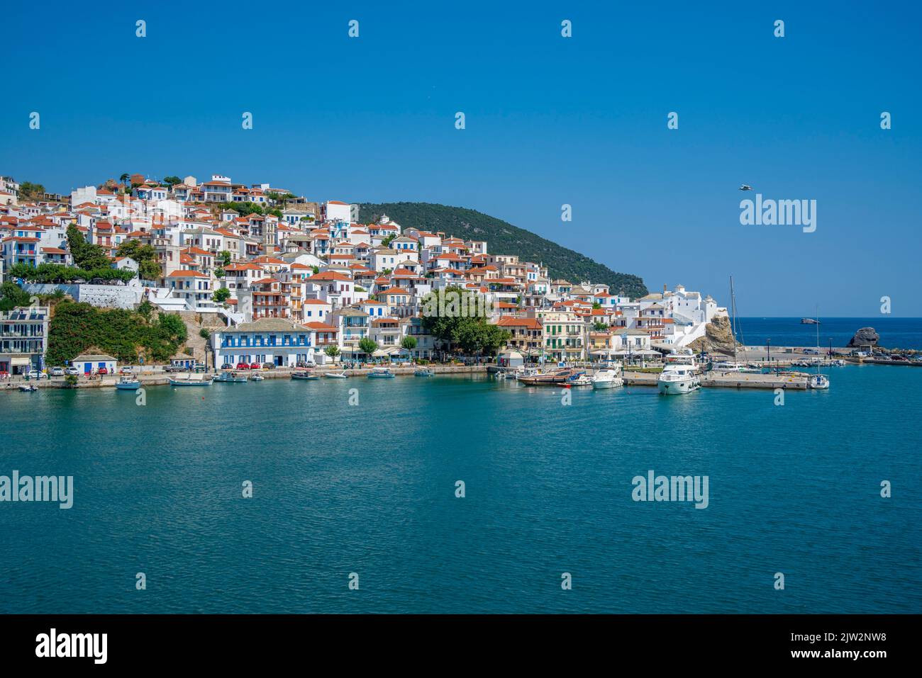 View of old town and sea from ferry, Skopelos Town, Skopelos Island, Sporades Islands, Greek Islands, Greece, Europe Stock Photo