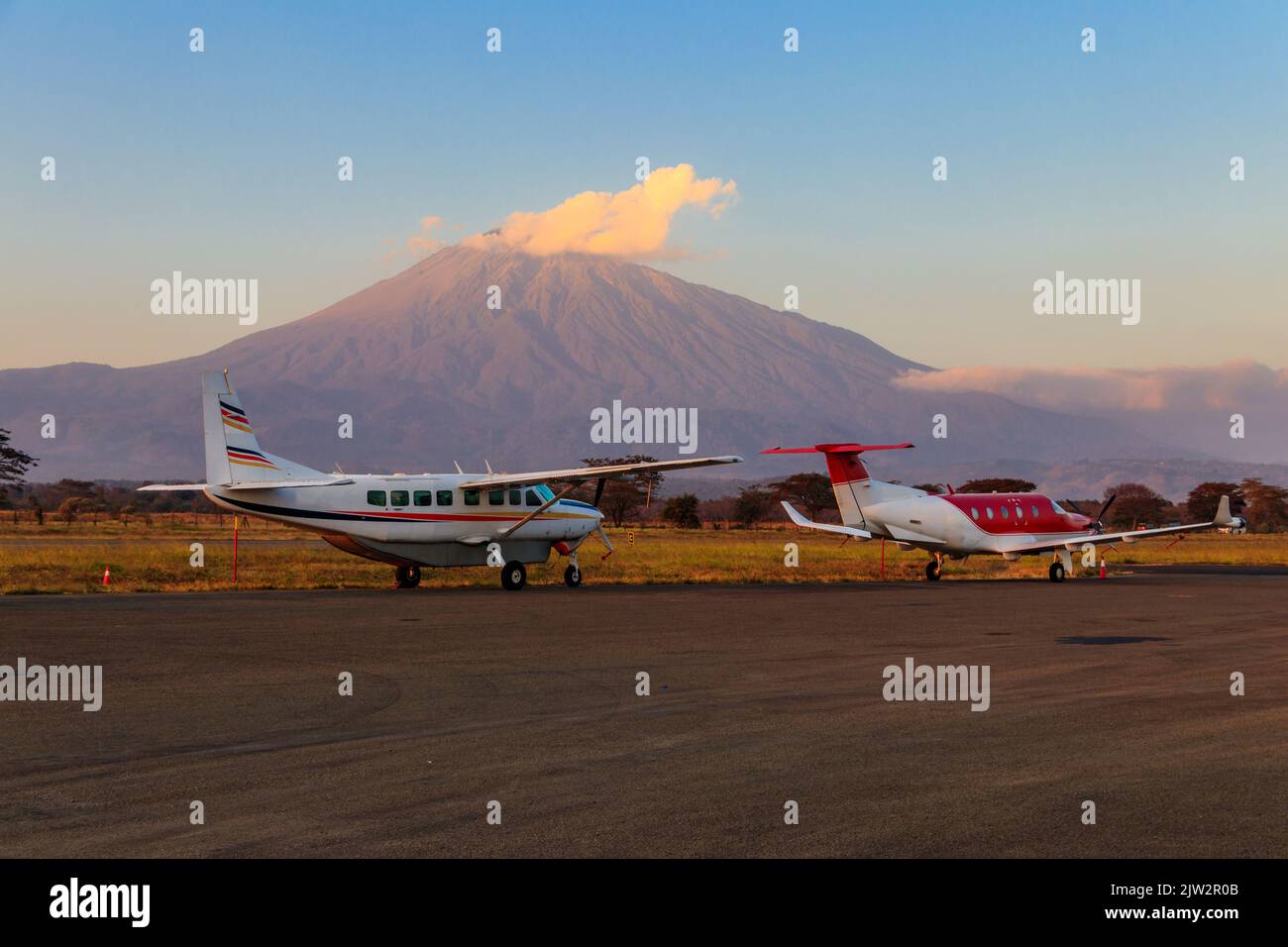 Small propeller airplanes on a background of Meru mountain in Arusha airport, Tanzania Stock Photo