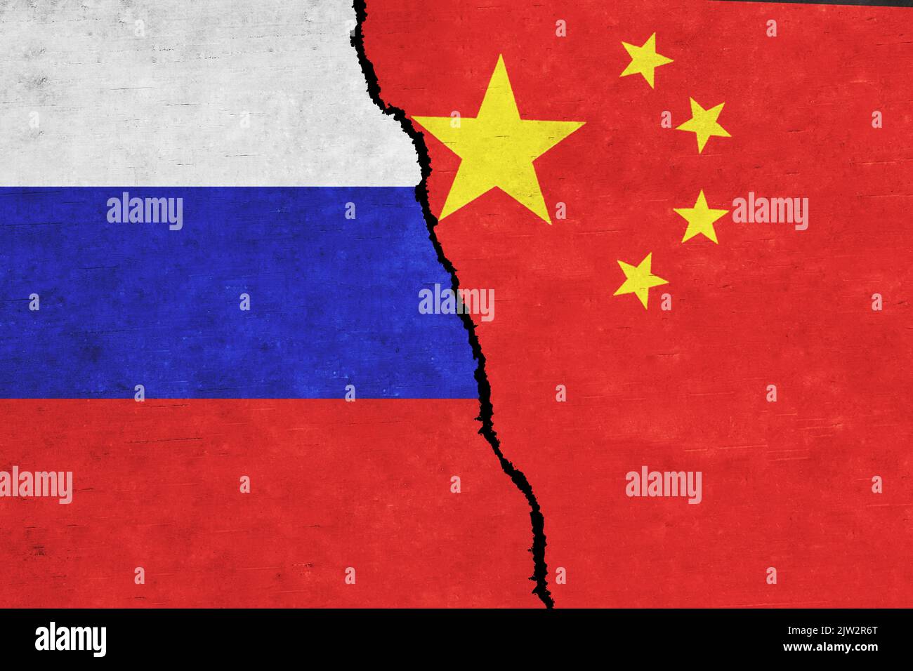 Russia and China painted flags on a wall with a crack. Russia and China