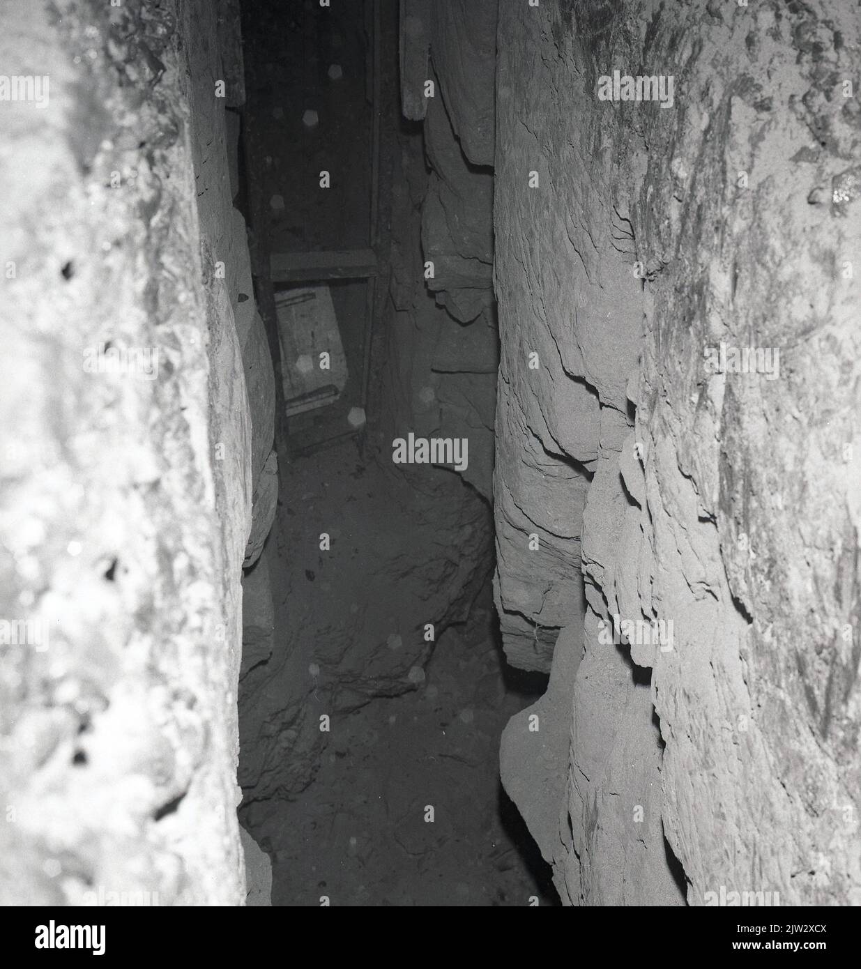 1960s, historical, inside an old, abandoned mine shaft, showing the wooden steps at the far end of the narrow tunnel, Townshill, Fife, Scotland, UK. Stock Photo