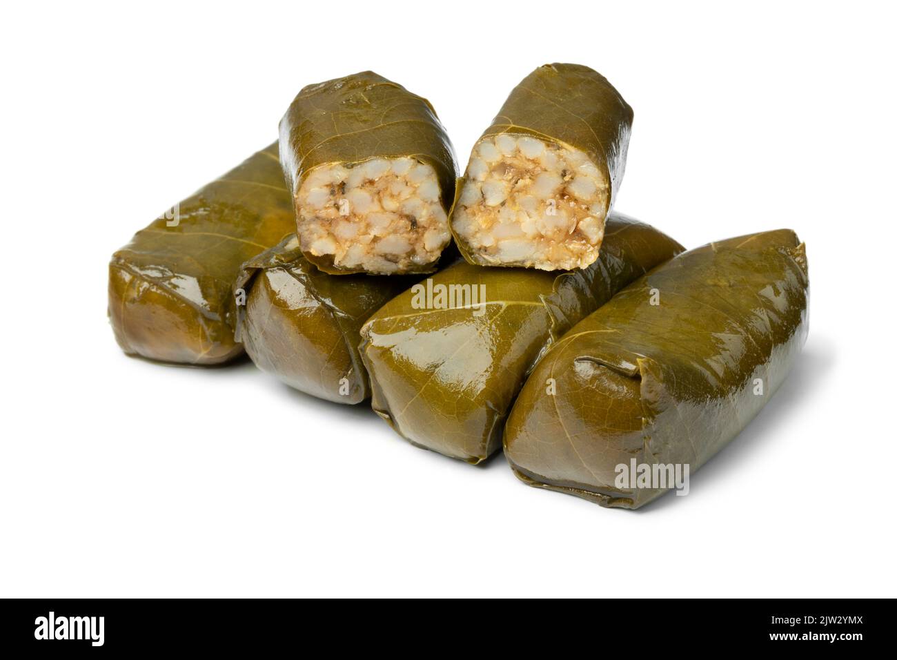 Whole and halved pieces Greek dolmades isolated on white background close up Stock Photo