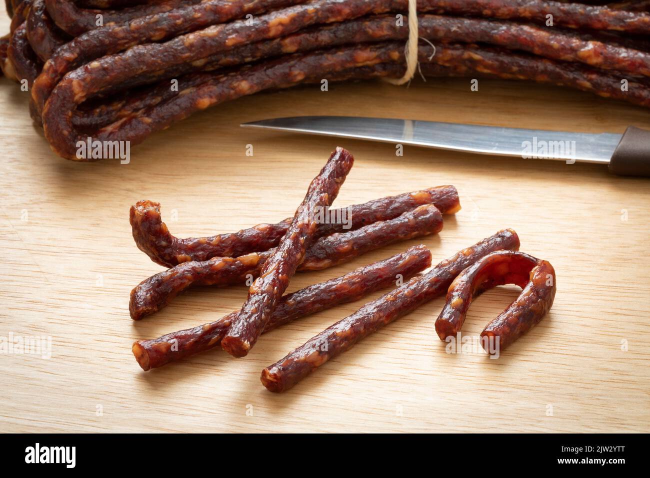 Pieces of traditional Croatian  dry sausage, mini Kobasica, on a cutting board close up Stock Photo