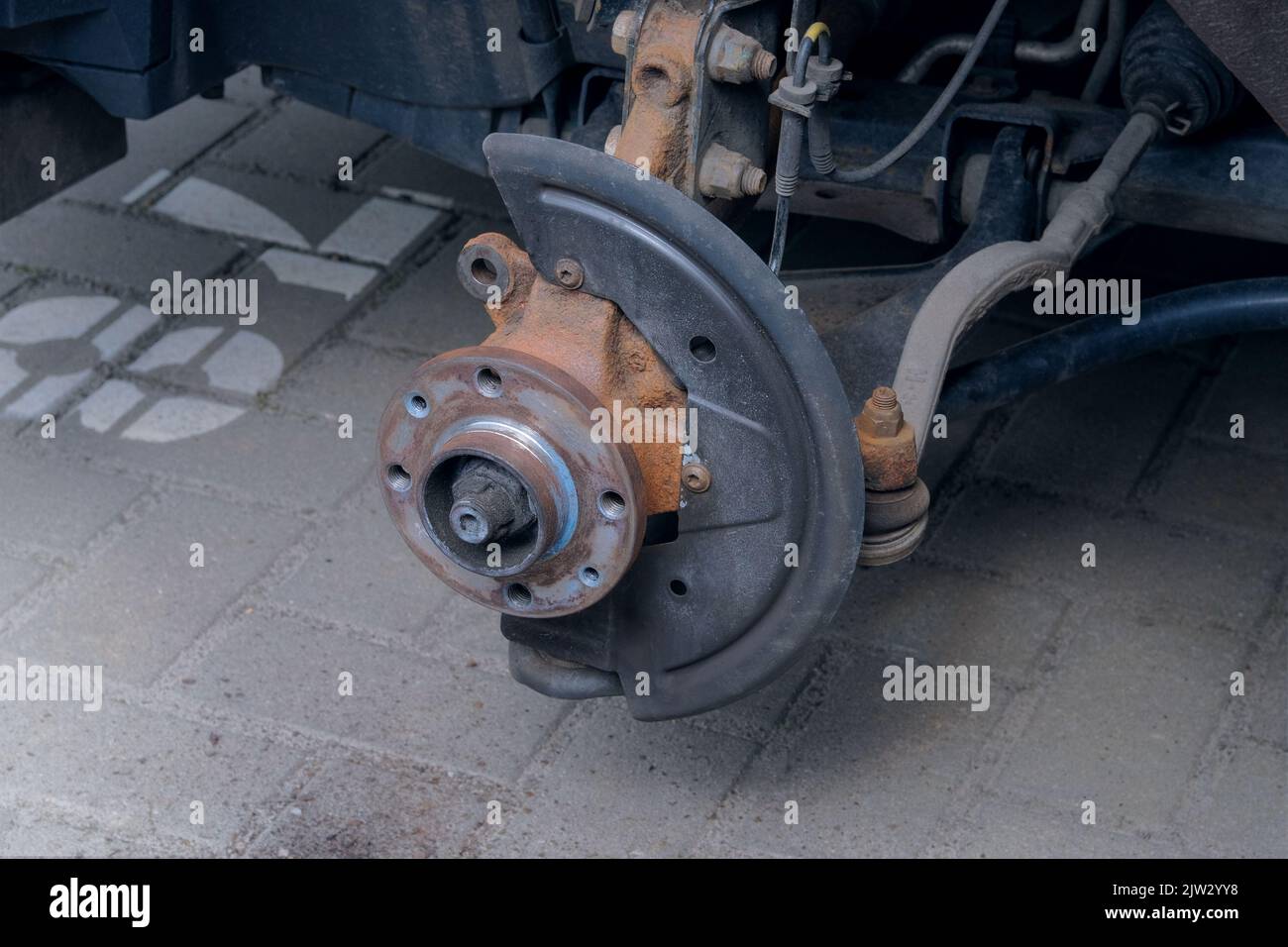 Repair of a wheel on a passenger car. Wheel balancing or repair. Car repair concept. Stock Photo