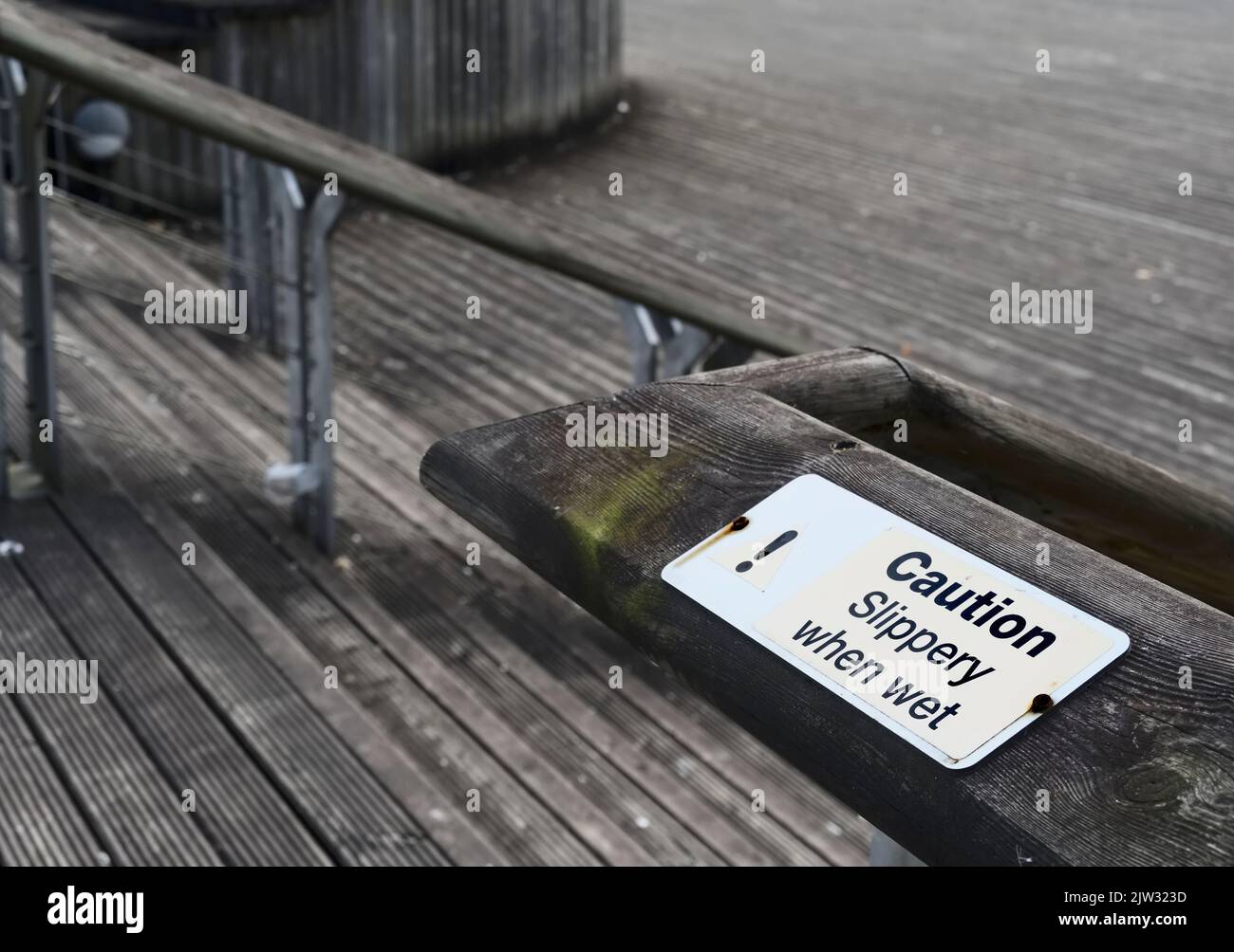 Slippery when wet warning sign at steps Stock Photo - Alamy