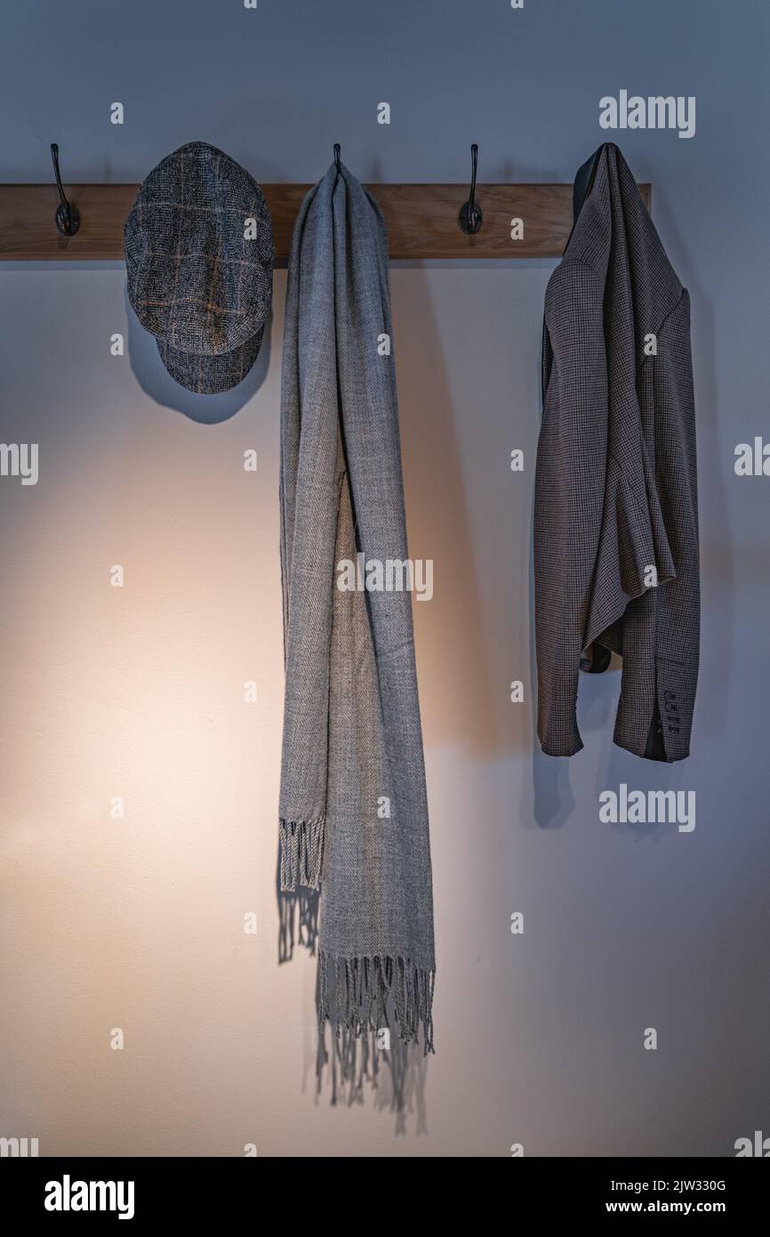 Vintage beret, scarf and jacked hanging on hanger on display
