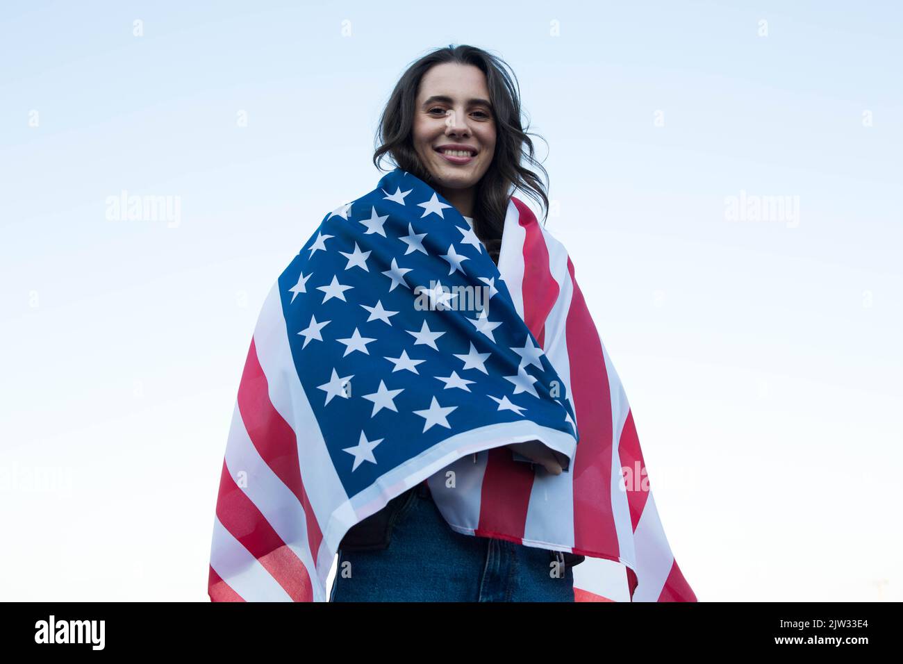Outdoors portrait of caucasian woman covered with american flag. 4 july ...