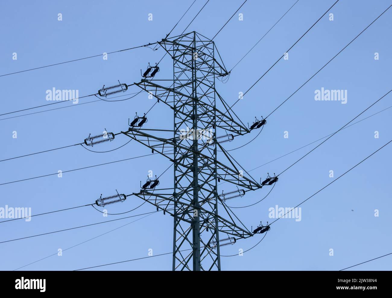 high voltage power pole and lines against the blue sky Stock Photo - Alamy