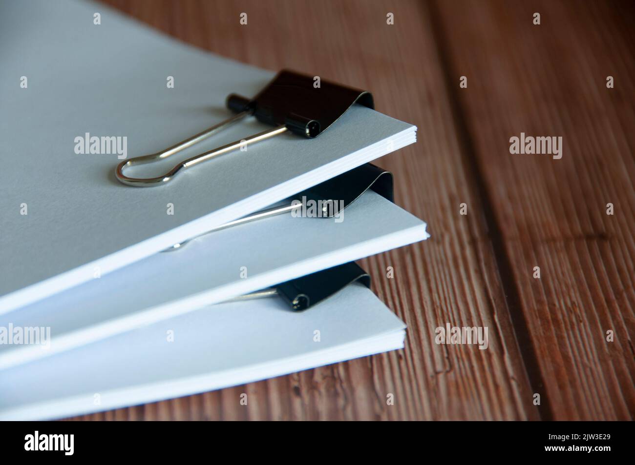 Paper stack of pile of documents on wooden desk. Copy space and business offices concept. Stock Photo