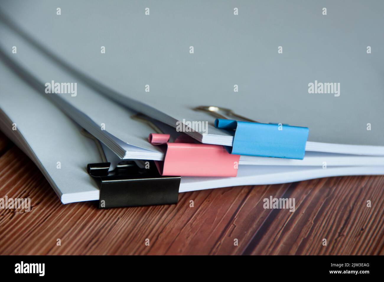 Paper stack of pile of documents on wooden desk. Copy space and business offices concept. Stock Photo