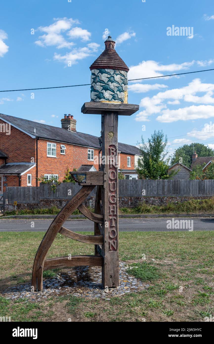 Broughton village sign in Hampshire, England, UK. A decorative village sign with a dovecote on top Stock Photo