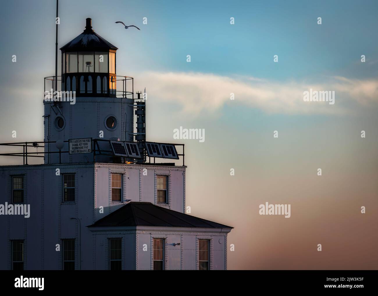 The morning sun begins to shine on the Lake Michigan lighthouse at Manitowoc, Wisconsin. Stock Photo