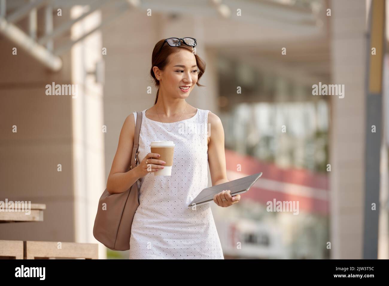 Attractive asian woman walking hi-res stock photography and images - Alamy