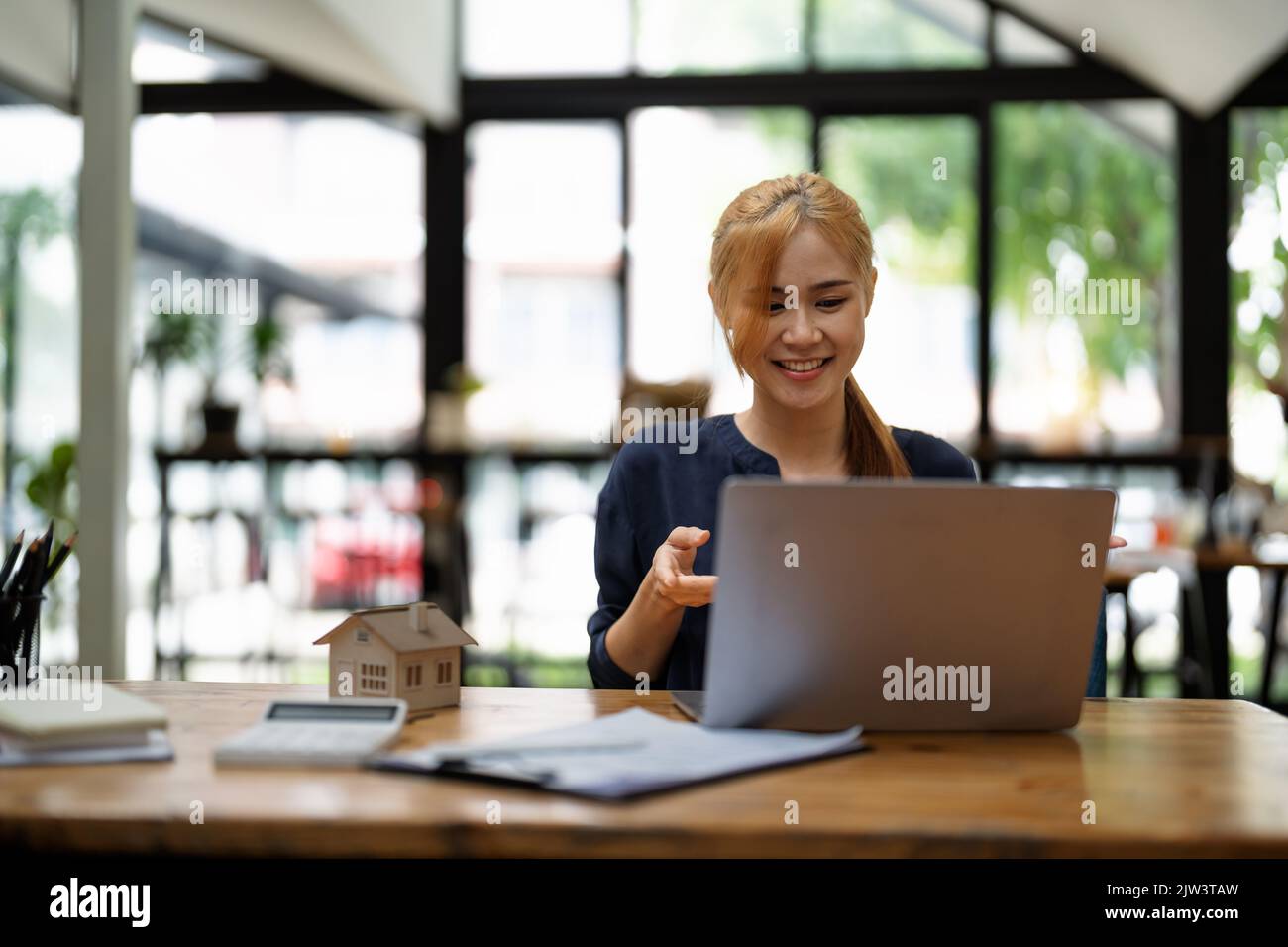 Real estate agent on video call in modern office Stock Photo Alamy