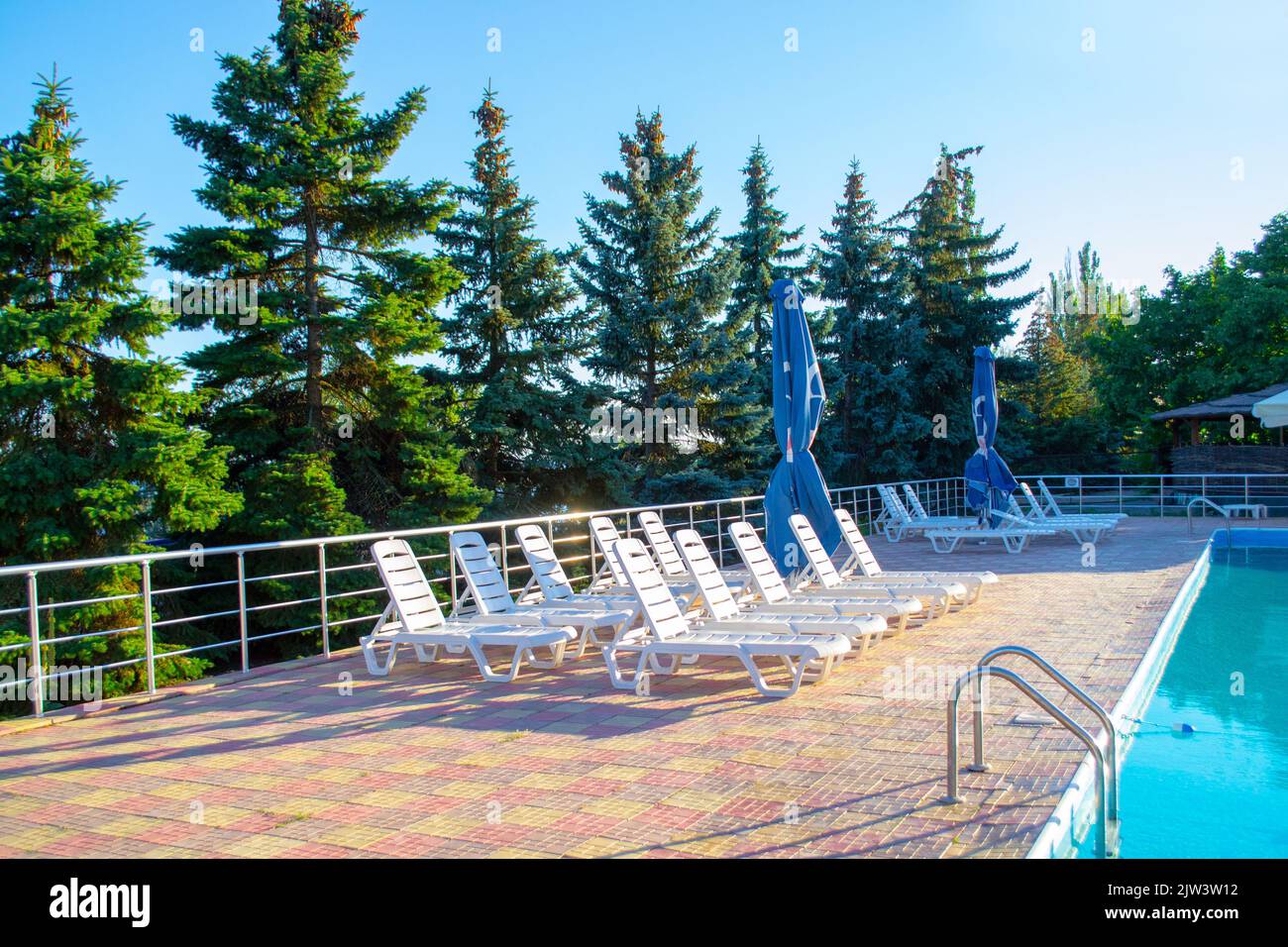 Primorsk, Ukraine. Poolside. Sunbeds near swimming pool surrounded by