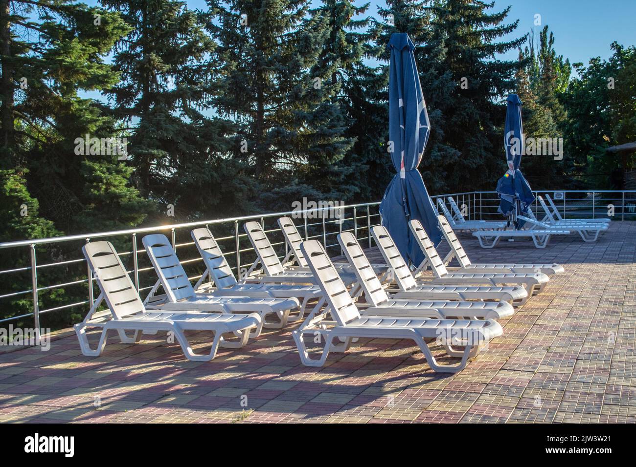 Primorsk, Ukraine. Poolside. Sunbeds near swimming pool surrounded by