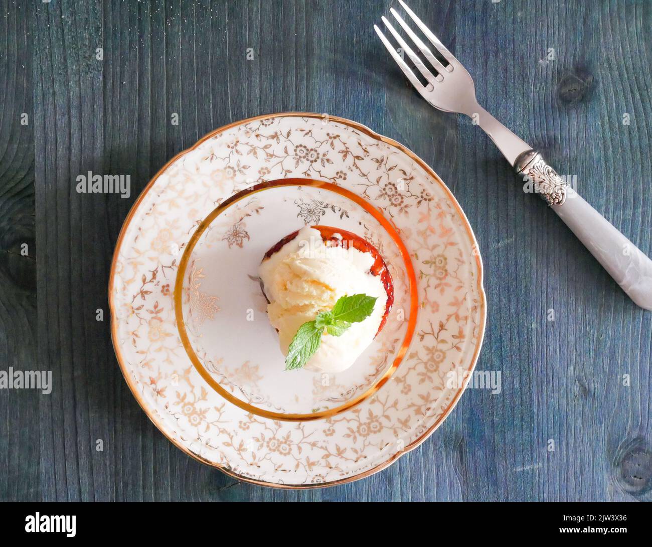 Caramelized peach with sugar and butter, vanilla ice cream and mints Stock Photo