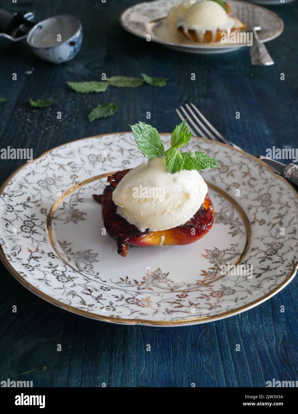 Caramelized peach with sugar and butter, vanilla ice cream and mints