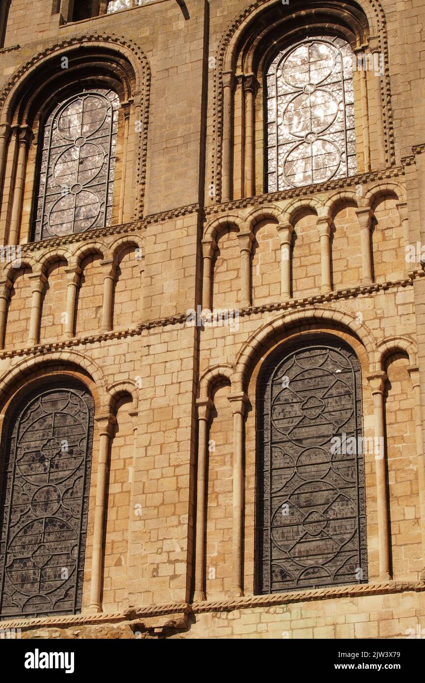 A view of some of the windows of Ely cathedral, Cambridgeshire, England, showing the intricate details in the stone work surrounding them Stock Photo